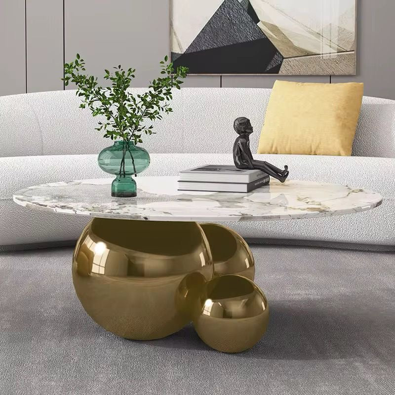 Hollywood oval marble look coffee table on polished gold sphere base, view 3