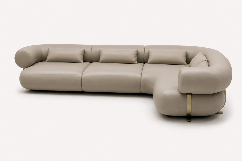 Aristo curved sectional in vegan leather with brass-tone base details