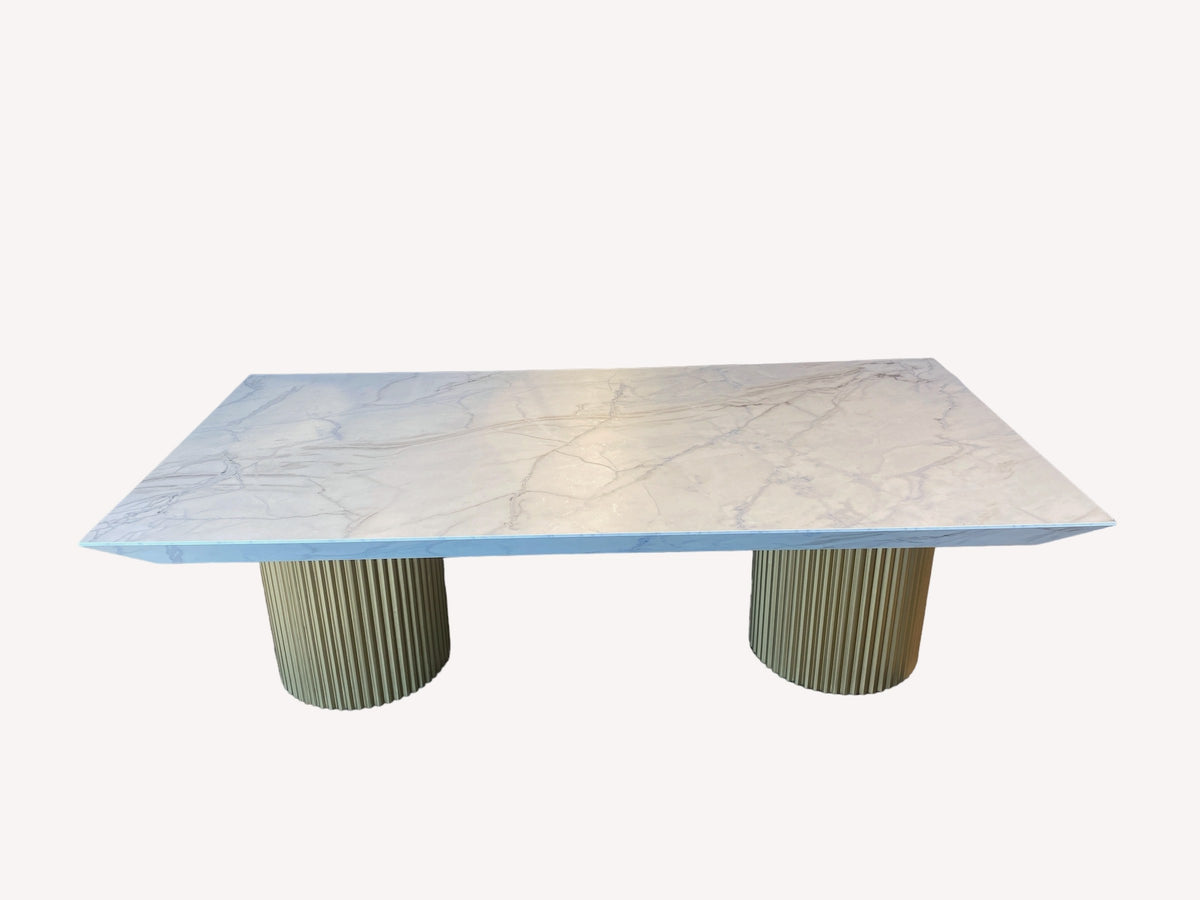 King marble look dining table on fluted gold drums