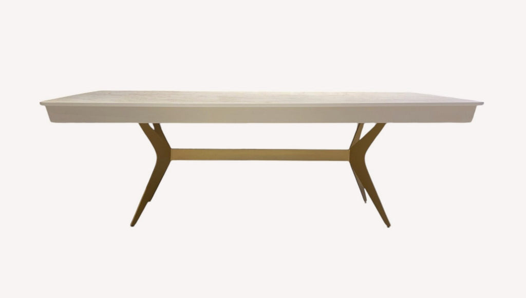 Bell dining table with light top and angled bronze legs
