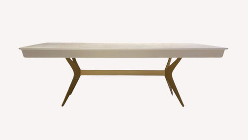 Bell dining table with light top and angled bronze legs