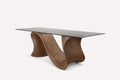 Anaconda dining table with sculptural wave wood base and glass top
