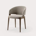 Sylvia dining chair with dark solid wood frame and rounded upholstered back