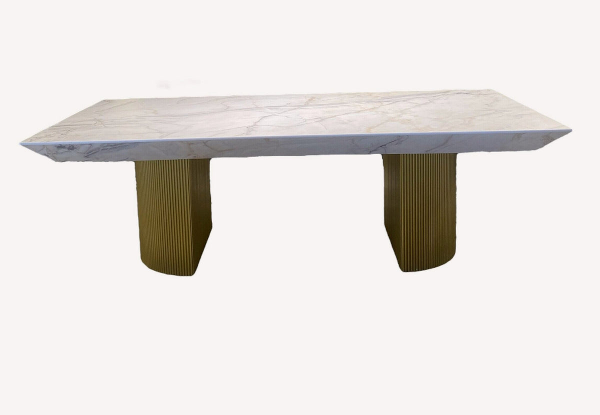 King marble look dining table on fluted gold pedestals