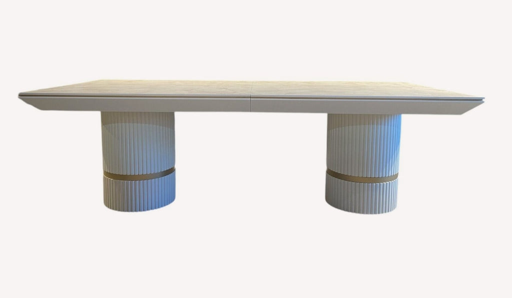 Imperia dining table on two fluted white pedestals with gold band