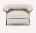 Aristo rounded accent chair with leather exterior and metal legs
