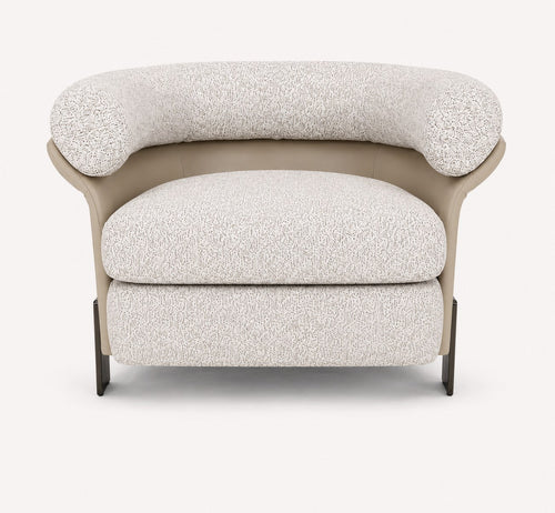 Aristo rounded accent chair with leather exterior and metal legs
