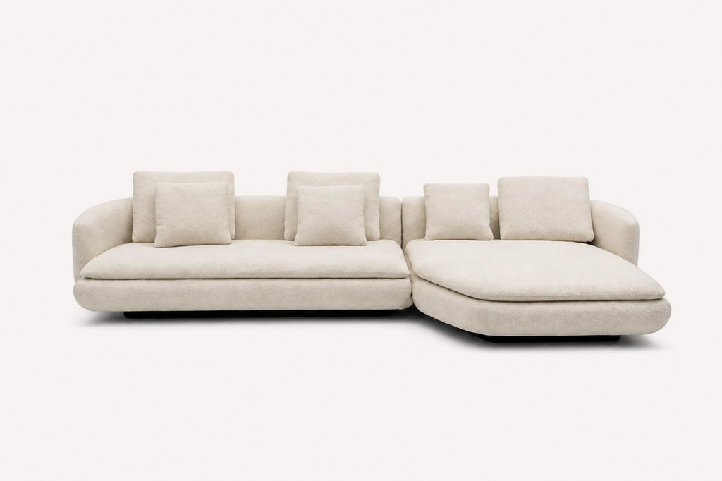 Lauren curved chaise sectional with loose back cushions and black base