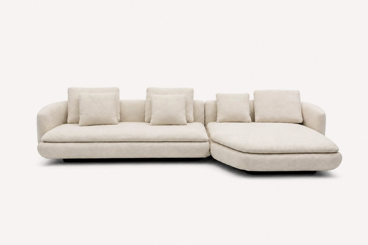 Lauren curved chaise sectional with loose back cushions and black base