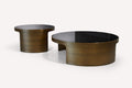 Pair of round smoked glass nesting coffee tables with brushed bronze bases