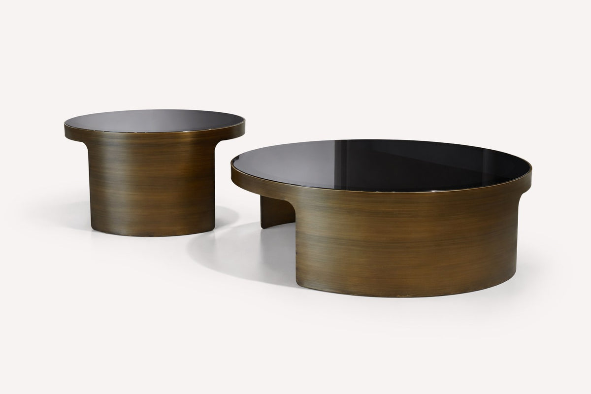 Pair of round smoked glass nesting coffee tables with brushed bronze bases