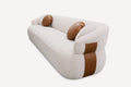 Mila organic curved sofa with round bolster pillows and leather side panels