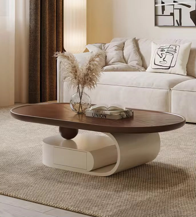 Queen oval walnut coffee table on curved cream base with drawer, view 3